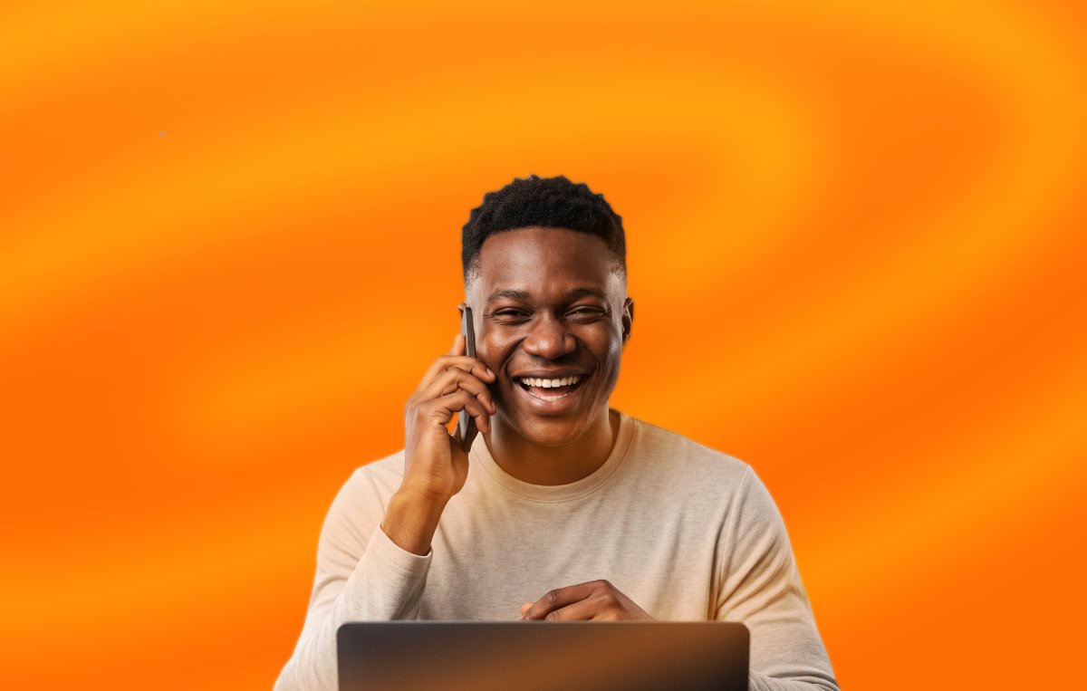Man on a phone call while using a laptop